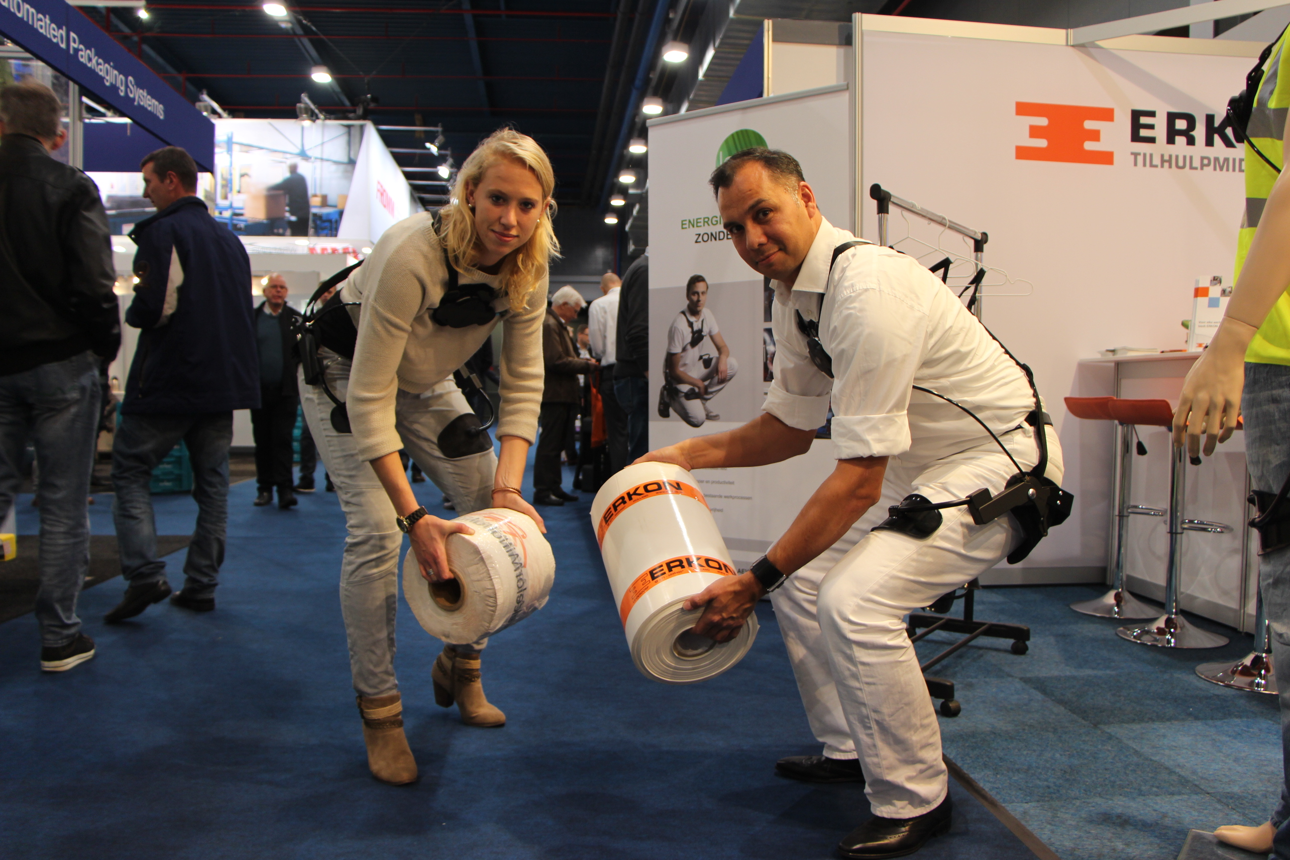 Linda van der Meijden en Duncan Treffers in actie met de Laevo, een exoskelet dat ervoor zorgt dat de rugspieren van een orderpicker veertig procent minder worden belast
